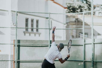 man in white t-shirt playing basketball during daytime